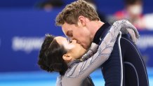 Ice dancers and real-life couple Madison Chock and Evan Bates of the USA share a kiss during the free dance event of the team figure skating competition at the 2022 Winter Olympic Games, at the Capital Indoor Stadium.