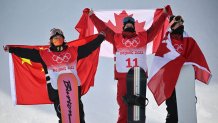 From left: silver medallist China's Su Yiming, gold medallist Canada's Max Parrot and bronze medallist Canada's Mark McMorris pose on the podium after the Snowboard Men's Slopestyle final run during the 2022 Winter Olympics at the Genting Snow Park H & S Stadium in Zhangjiakou, China on Feb. 7, 2022.