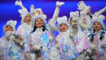 Children bearing snowflakes wave at the audience during the Closing Ceremony at the 2022 Winter Olympic Games, Feb. 20, 2022, in Beijing.