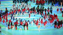 Members from the French and Japanese delegations dance at the 2022 Winter Olympics Closing Ceremony, Feb. 20, 2022 in Beijing.