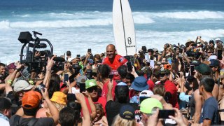 Kelly Slater celebrates after winning the men's competition at Banzai Pipeline on Feb. 05, 2022, in Haleiwa, Hawaii.
