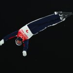 Justin Schoenefeld of Team United States in air during the Freestyle Skiing Mixed Team Aerials on Day 6 Beijing 2022 Winter Olympics Day of the at Genting Snow Park, Feb. 10, 2022 in Zhangjiakou, China. The US will advance to the team aerials final.
