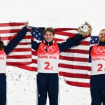 Gold medallists Ashley Caldwell, Christopher Lillis and Justin Schoenefeld of Team USA celebrates their gold medal win during the flower ceremony at Genting Snow Park, Feb. 10, 2022, in Zhangjiakou, Beijing.