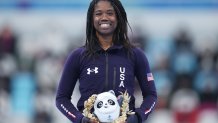 Gold medallist Erin Jackson of Team United States celebrates during the Women's 500m flower ceremony at the 2022 Winter Olympic Games, Feb. 13, 2022, in Beijing.