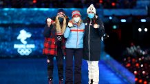 Gold medallist Therese Johaug of Team Norway, center, silver medallist Jessie Diggins of Team United States, left, and bronze medallist Kerttu Niskanen of Team Finland  pose with their medals during the Women's 30km Mass Start medal ceremony at the 2022 Winter Olympics Closing Ceremony, Feb. 20, 2022, in Beijing.