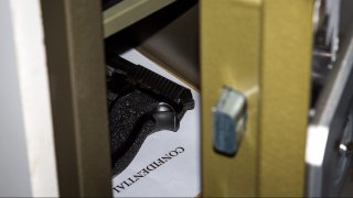 A gun sits in a safe in this undated file photo.