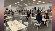 NBC staff sit and eat in the dining hall, known as the NBC commissary, at the Winter Olympics in Beijing, Feb. 8, 2022.