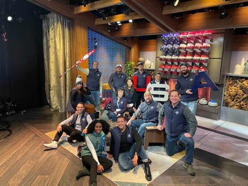 NBC 7 presenter Steven Luke (right) poses for a photo with colleagues in a television studio at the Beijing Winter Olympics on February 20, 2022.