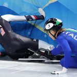 Kristen Santos and Arianna Fontana crash into the boards