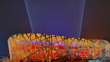 Light emits up into the sky from the "Bird's Nest" during a closing ceremony rehearsal at the Winter Olympics in Beijing, Feb. 18, 2022.