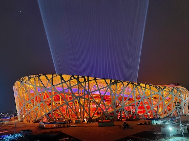 Light emits up into the sky from the "Bird's Nest" during a closing ceremony rehearsal at the Winter Olympics in Beijing, Feb. 18, 2022.
