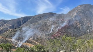 Cal Fire crews were battling a small brush fire south of Otay Mountain