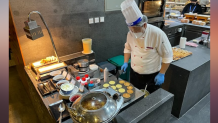 A chef at a dining hall in Beijing makes breakfast for patrons at the Winter Olympics, Feb. 8, 2022.