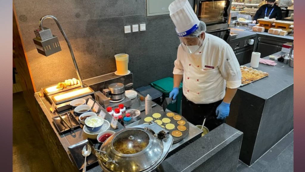 A chef at a dining hall in Beijing makes breakfast for patrons at the Winter Olympics, Feb. 8, 2022.