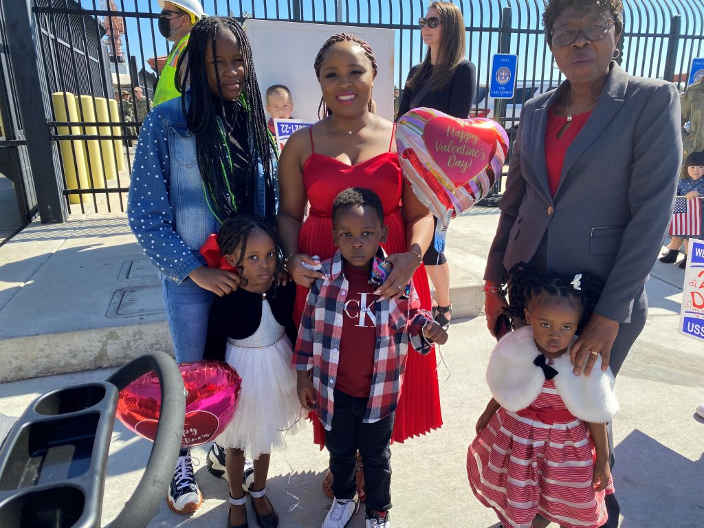 A family awaits the arrival of their loved one as USS Carl Vinson returns to San Diego on Monday, Feb. 14, 2022.