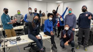 Journalists from NBC owned and operated stations across the U.S. gather to pose for a photo in Beijing during the Winter Olympics, Jan. 31, 2022.