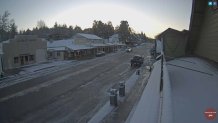 Drivers in Julian, California drive slowly amid snowy conditions in the mountain community on Wednesday, Feb. 16, 2022.