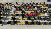 Spectators wave flags inside the Big Air Shougang Winter Olympic venue in Beijing, Feb. 9, 2022.