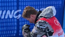 Snowboard legend Shaun White is overcome with emotion after his final halfpipe run at the Winter Olympics in Beijing, Feb. 10, 2022.