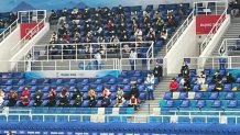 Spectators watch competitors inside the Curling Arena at the National Aquatics Center, also known as the "ice cube," at the Winter Olympics in Beijing, Feb. 2, 2022.