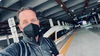 NBC 7 anchor Steven Luke takes a selfie in front of a bullet train in Beijing, Feb. 5, 2022.