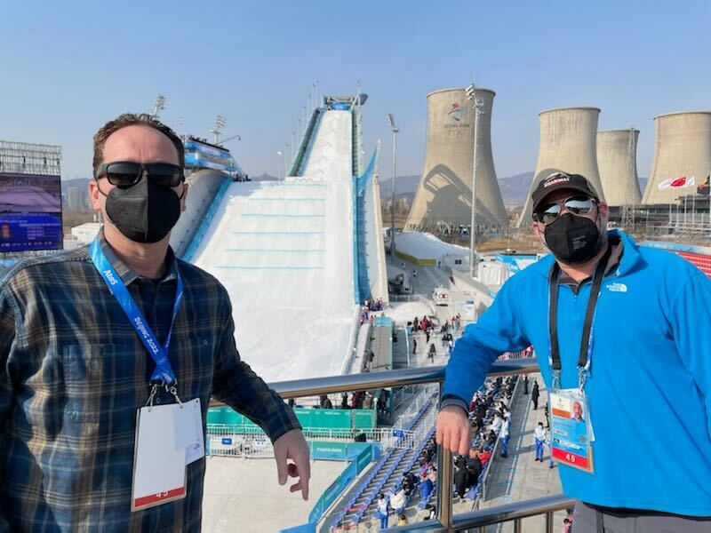 NBC 7 anchor Steven Luke (left) and NBC 7 Media Manager Jason Guinter (right) pose for a photo at the Big Air Shougang Olympic venue in Beijing, Feb. 9, 2022.