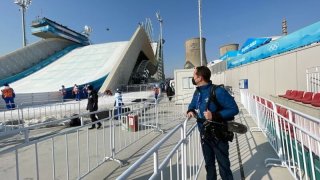 NBC 7 anchor Steven Luke stands inside the Big Air Shougang Olympic venue with his camera gear at the Winter Olympics in Beijing, Feb. 9, 2022.