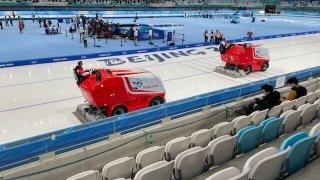 Two zambonis clean the ice at the speed skating rink at the Winter Olympics in Beijing, Feb. 15, 2022.