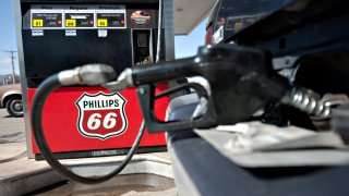 A Phillips 66 logo is seen on a gas pump as a car is filled a Beck’s station in Princeton, Illinois.