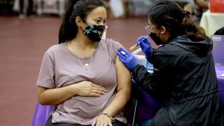 A woman receives a Pfizer vaccination booster shot at Eugene A. Obregon Park on Nov. 3 in Los Angeles.