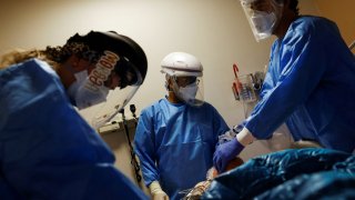 Medical staff treat a coronavirus disease (COVID-19) patient in the Intensive Care Unit (ICU) at the Providence Mission Hospital in Mission Viejo, California, January 25, 2022.