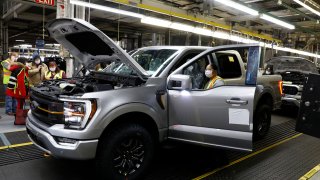 Employees work on the 40 millionth Ford Motor Co. F-Series truck on the assembly line at the Ford Dearborn Truck Plant on January 26, 2022 in Dearborn, Michigan.