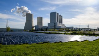 A solar energy field stands next to the Lippendorf coal-fired power plant on May 10, 2021 in Lippendorf, Germany.