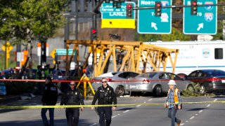 FILE- Emergency crews work at the scene of a construction crane collapse that killed four people on April 27, 2019, in the South Lake Union neighborhood of Seattle. A jury on Monday, March 14, 2022, awarded more than $150 million to some of the victims of the high-profile accident.