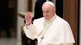 Pope Francis waves as he arrives for an audience with members of the members of the Antoniano children choir, at the Vatican, Saturday, March 19, 2022.