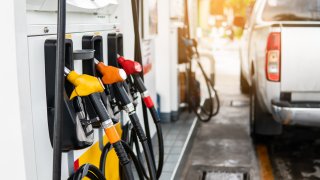 Fuel nozzle to refill fuel in car at gas station.