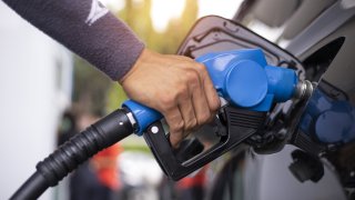 Driver fills up at a gas station