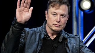 Elon Musk, founder of SpaceX and chief executive officer of Tesla, waves while arriving to a discussion at the Satellite 2020 Conference in Washington, D.C., on Monday, March 9, 2020.