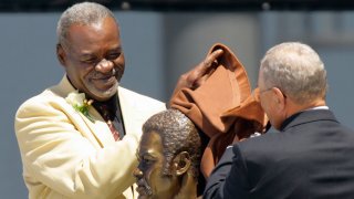 Former Dallas Cowboys great Rayfield Wright, left, unveils his bronze bust with presenter L.J. Lomax, right, during ceremonies at the Pro Football Hall of Fame, Saturday, Aug. 5, 2006, in Canton, Ohio.