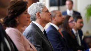 Secretary of Commerce Secretary Gina Raimondo, second from left, and Attorney General Merrick Garland center, listen as President Joe Biden speaks before signing an executive order aimed at promoting competition in the economy, in the State Dining Room of the White House, Friday, July 9, 2021, in Washington.