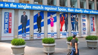 Pictured in promotional posters outside Fox News studios at News Corporation headquarters in New York on Saturday, July 31, 2021, are hosts Tucker Carlson, Sean Hannity, Laura Ingraham, Maria Bartiromo, Stuart Varney, Neil Cavuto and Charles Payne.