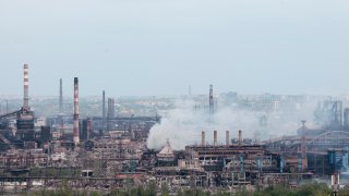 Smoke rises from the Metallurgical Combine Azovstal in Mariupol, in territory under the government of the Donetsk People's Republic, eastern in Mariupol, Ukraine, Thursday, May 5, 2022. Heavy fighting is raging at the besieged steel plant in Mariupol as Russian forces attempt to finish off the city's last-ditch defenders and complete the capture of the strategically vital port.