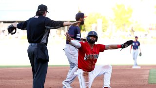 Indianapolis Indians outfielder Canaan Smith-Njigba (28) signals he is safe along with the home plate umpire on the play at third during a MiLB baseball game between the Louisville Bats and the Indianapolis Indians on May 07, 2022 at Victory Field in Indianapolis, IN.