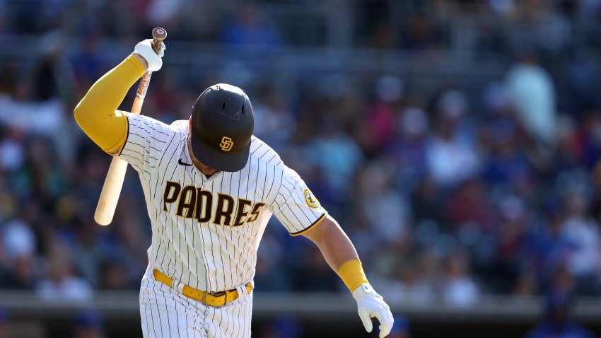 San Diego Padres' Alfonso Rivas advances from second base before being  tagged out at third off a fielder's choice by Fernando Tatis Jr. during the  fourth inning of a baseball game against