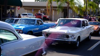 Several classic cars cruise down Grand Avenue in Escondido on an unspecified date.