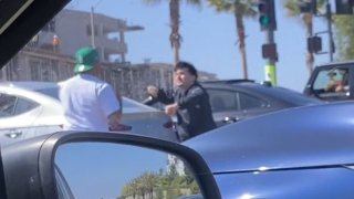 A still from a video shot by a bystander shows two drivers fighting at an intersection in Chula Vista before shots rang out. CVPD are investigating the possible road rage incident.