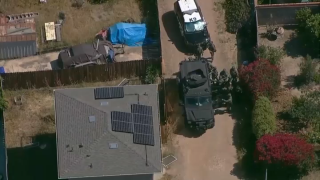 SWAT officers positioned near a home in South Park on May 13, 2022, after hot oil was reportedly thrown in an officer's face.