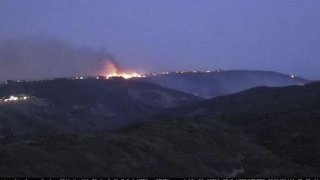 Time-lapse video shows the Coastal Fire as it spread in an Orange County canyon and burned uphill into a neighborhood.