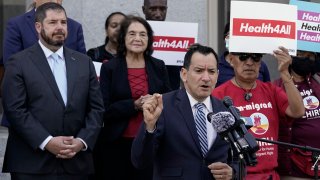 California Assembly Speaker Anthony Rendon, D-Lakewood, center, speaks in support of health care for all low-income immigrants living in the country illegally during a rally at the Capitol Sacramento, Calif., on Wednesday, June 29, 2022