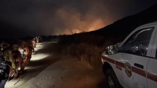 Cal Fire San Diego/San Diego County Fire crews march towards a wildfire that started in far east San Diego County on Sunday, June 12, 2022.